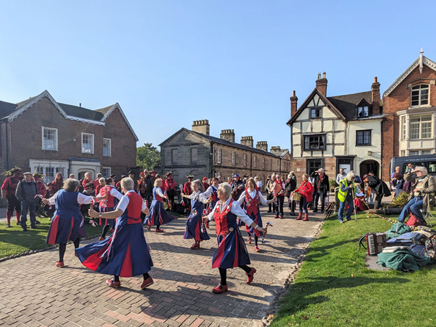 Nancy Butterfly dancing in front of other sides in the cathedral close